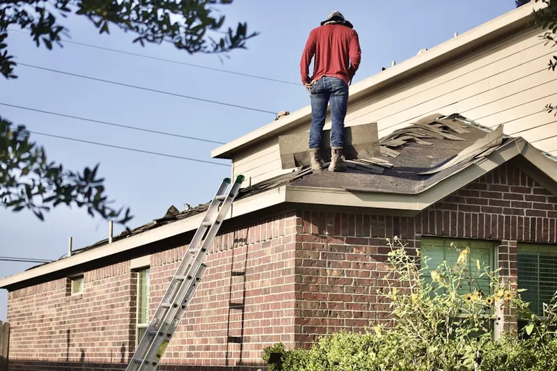 Professional roofer working on a residential roof in Columbus